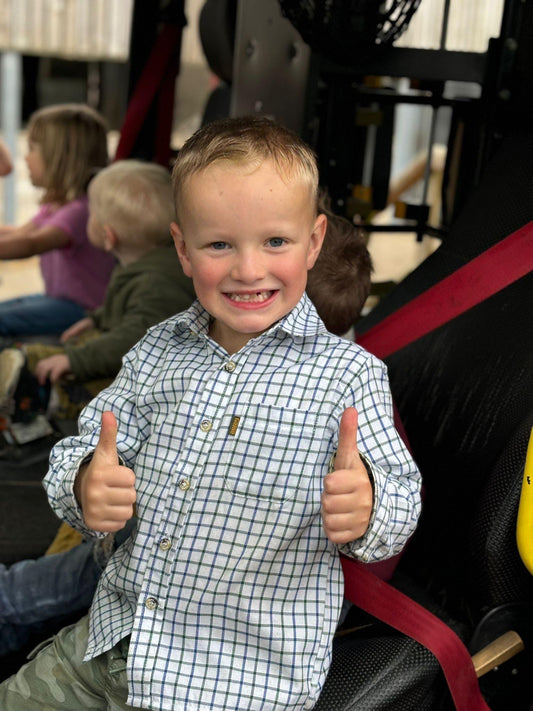 Boy wearing green and blue tattersall check shirt